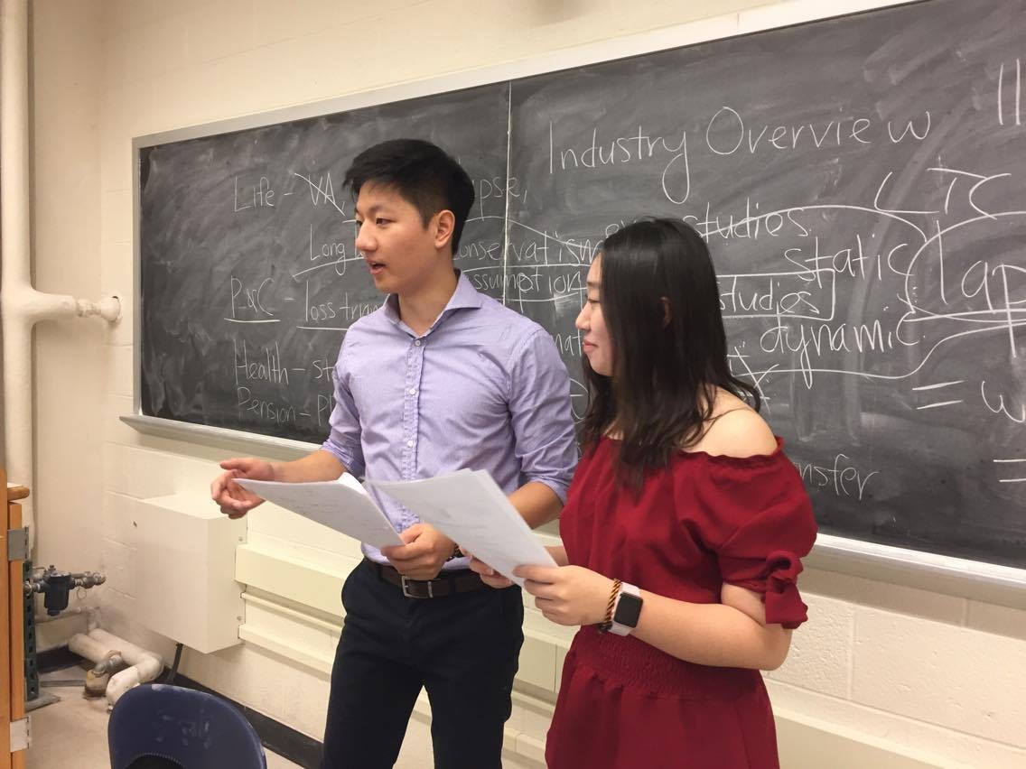  math students in front of white board giving presentation