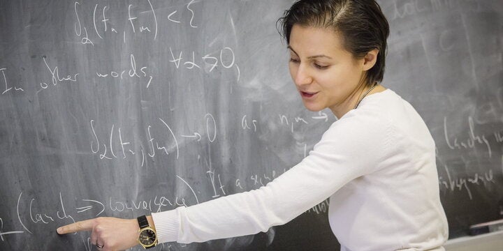 Mathematics professor at chalkboard.