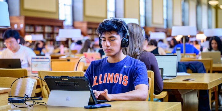 Student on laptop in library.