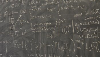 chalkboard with mathematical work