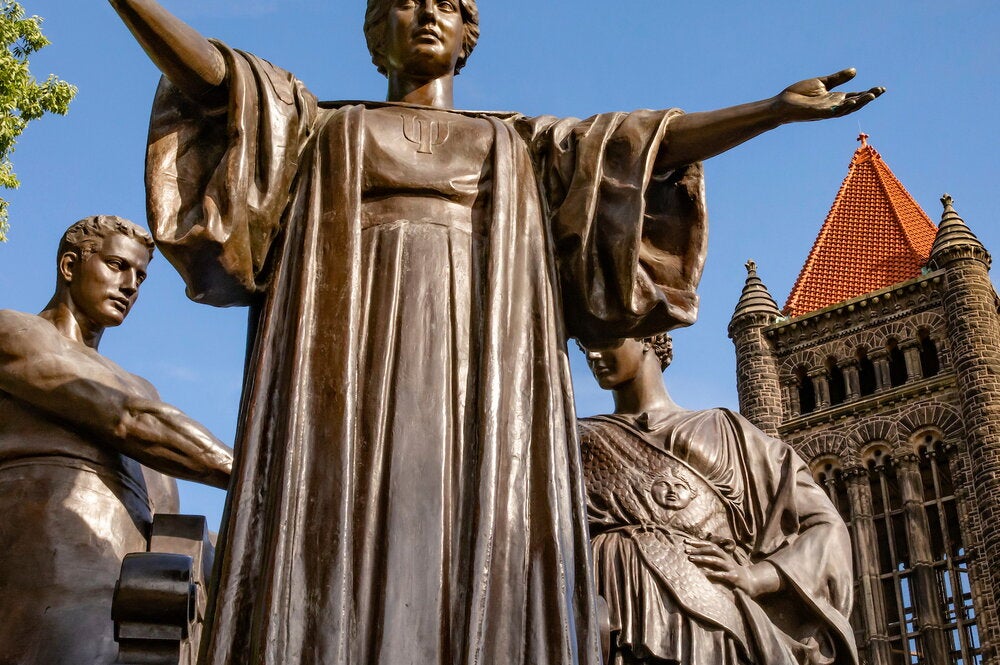 Statue with open arms in front of Altgeld Hall