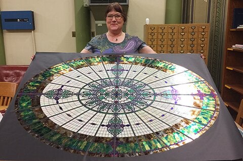 Jane Bergman with her replica of the Altgeld Hall glass dome.