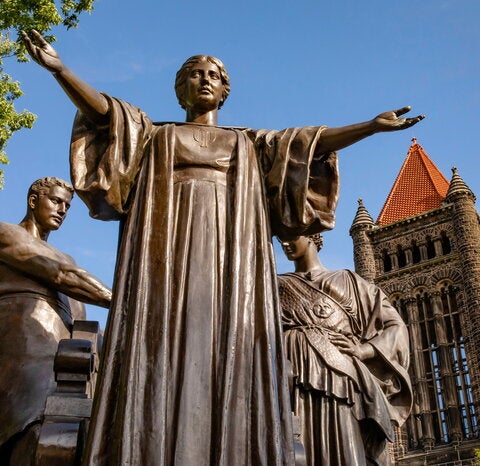 Statue with open arms in front of Altgeld Hall