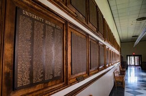 A series of plaques known as the "Bronze Tablet" is displayed in a library corridor.