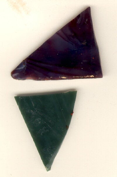 Pictured are pieces of glass found within the insulation of Altgeld Hall. These pieces were likely once part of the stained glass dome over the library lobby.