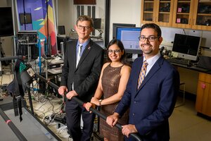 Richard Sowers, Rachneet Kaur and Manuel Hernandez stand next to treadmill in a lab. They are surrounded my monitors, electrical cords, and medical monitoring equipment 