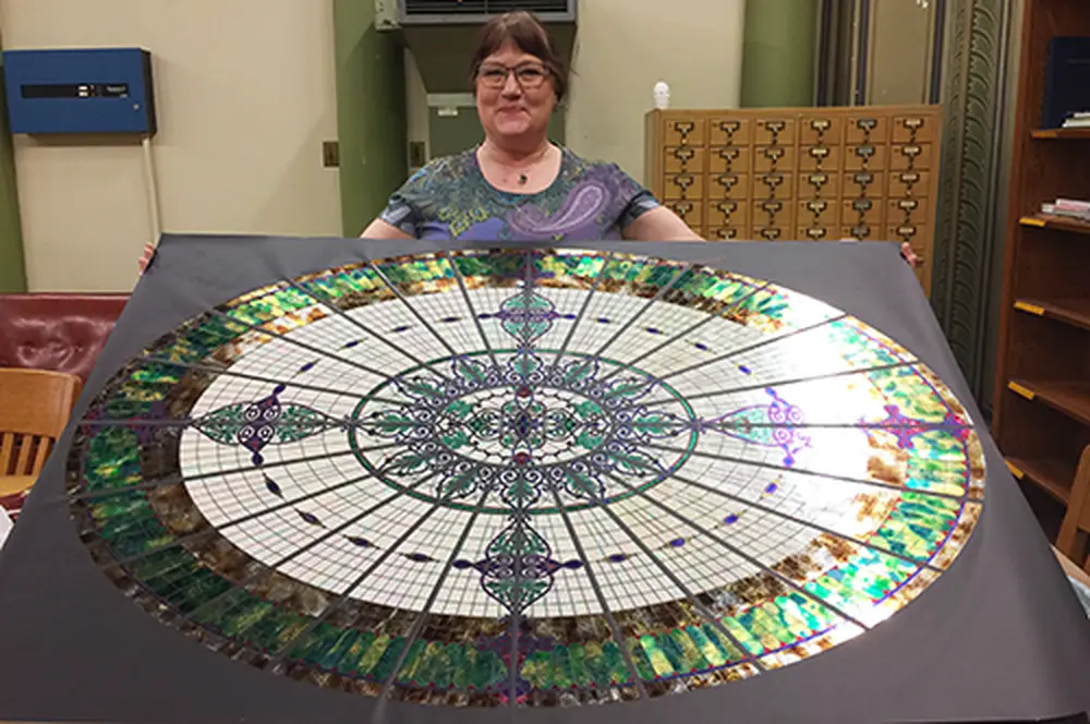 Jane Bergman with her replica of the Altgeld Hall glass dome. Jane Bergman with her replica of the Altgeld Hall glass dome.