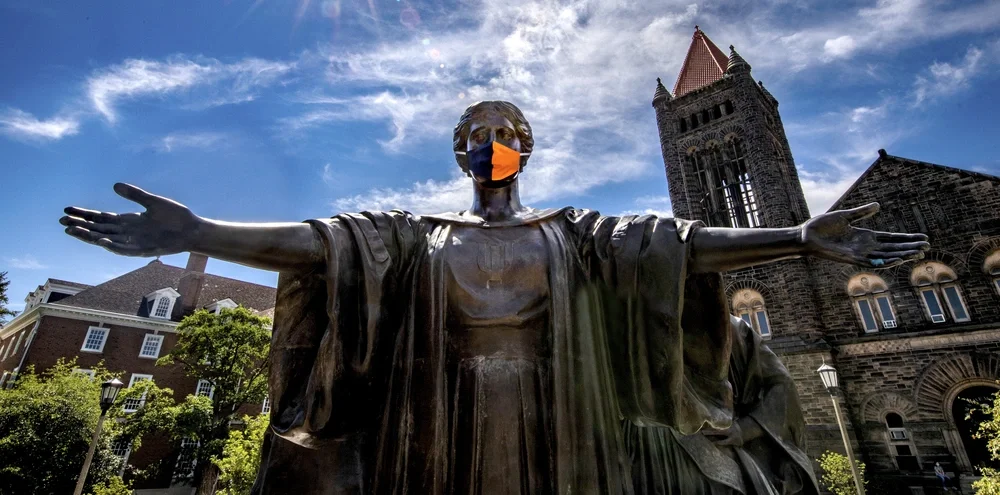 Alma Mater wearing a face covering with Altgeld Hall in the background. Alma Mater wearing a face covering with Altgeld Hall in the background.