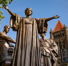 Statue with open arms in front of Altgeld Hall